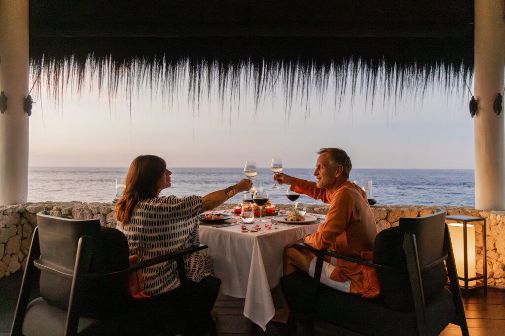 Couple enjoying a private romantic dinner by the sea at The Jing in North Bali